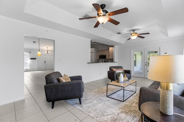 living room featuring french doors, a raised ceiling, crown molding, ceiling fan, and light tile patterned flooring