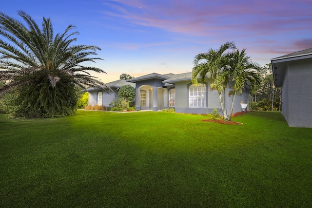 view of front of home with a yard