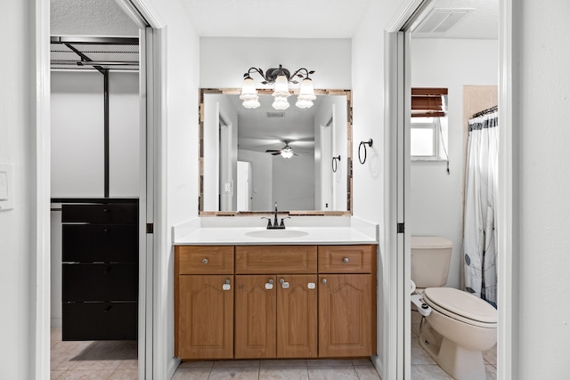 bathroom featuring toilet, vanity, tile patterned floors, and ceiling fan