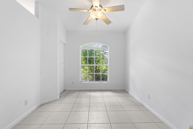 unfurnished room with ceiling fan and light tile patterned floors