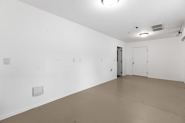 empty room with concrete flooring