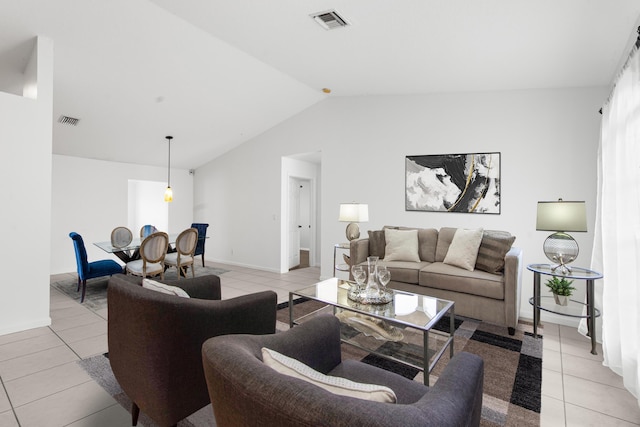 living room with lofted ceiling and light tile patterned floors