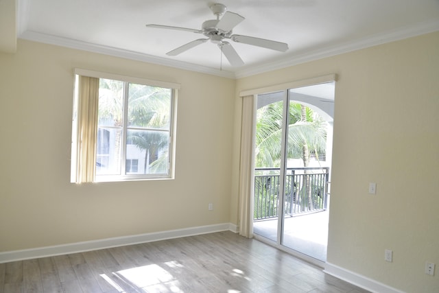 empty room with ceiling fan, light wood-type flooring, and crown molding