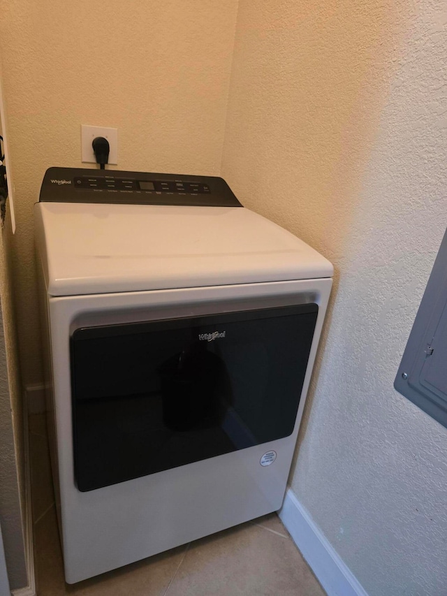 interior details with tile patterned floors and washer / clothes dryer