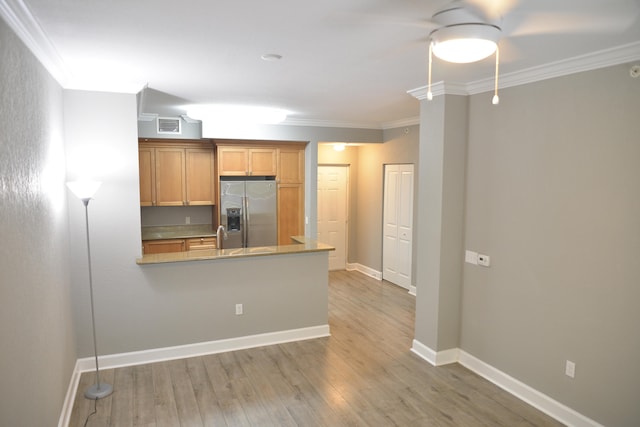 kitchen featuring ornamental molding, stainless steel refrigerator with ice dispenser, hardwood / wood-style floors, and kitchen peninsula