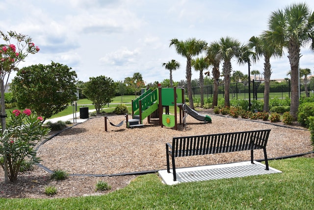 view of jungle gym featuring a lawn