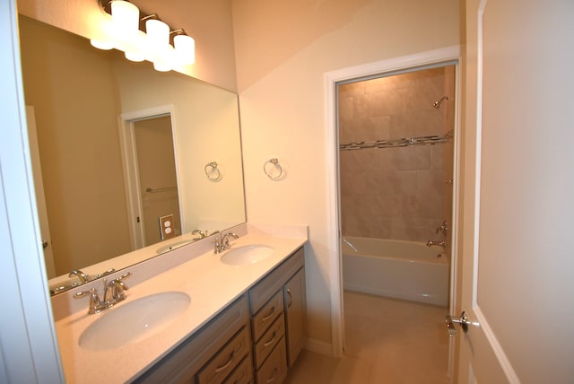 bathroom featuring vanity and tiled shower / bath combo