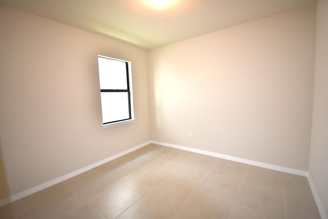 spare room featuring light tile patterned floors