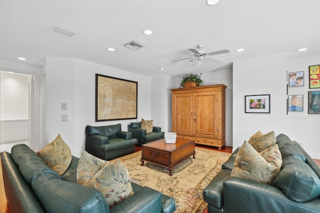 living room featuring ceiling fan and light hardwood / wood-style floors