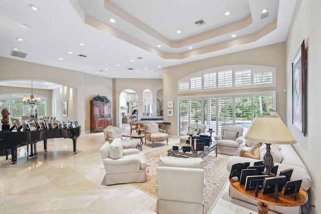 living room with a notable chandelier and a high ceiling