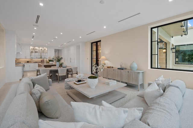 carpeted living room featuring sink