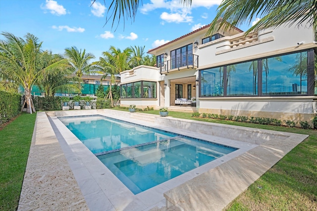 view of pool with a patio area, a yard, and an in ground hot tub