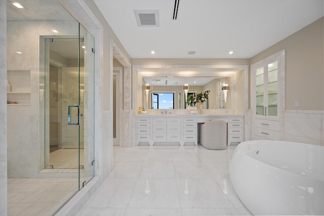 bathroom featuring vanity and separate shower and tub