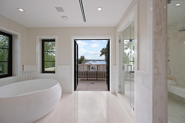 bathroom featuring shower with separate bathtub