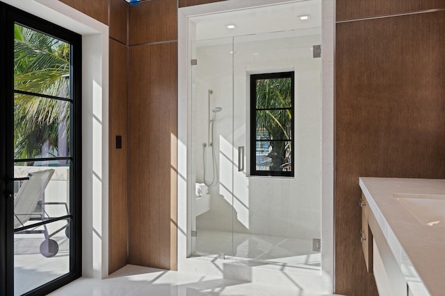 bathroom featuring vanity and a shower with shower door