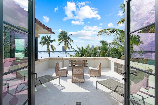 view of patio / terrace with outdoor lounge area and a water view