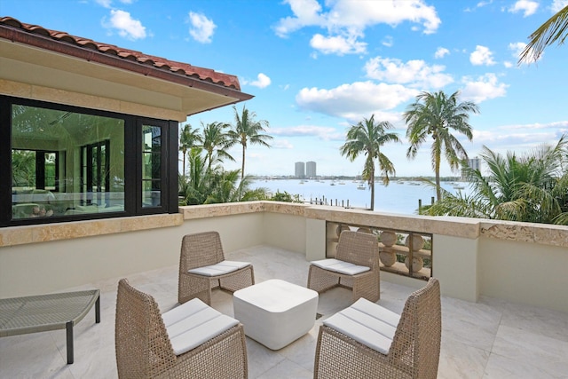 view of patio / terrace featuring a balcony and a water view