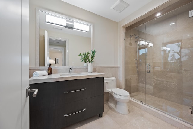 bathroom with walk in shower, vanity, and toilet