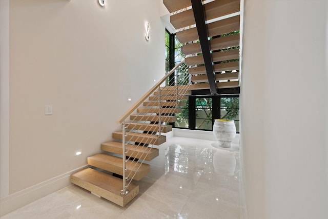 staircase with a wealth of natural light