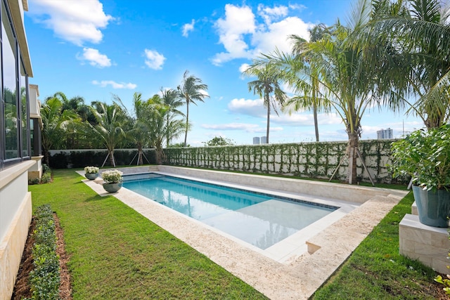 view of pool featuring a lawn