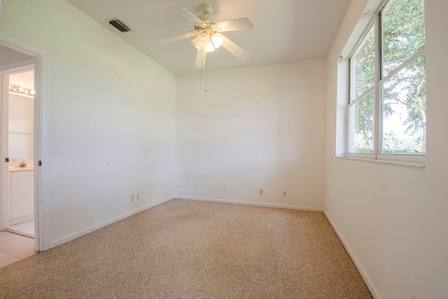 carpeted empty room featuring ceiling fan