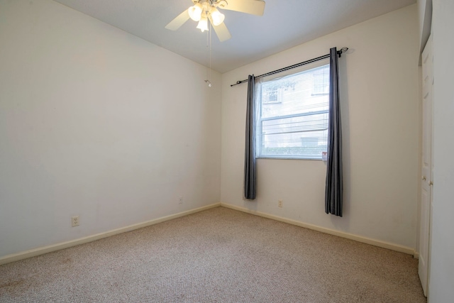 unfurnished room featuring ceiling fan and light carpet