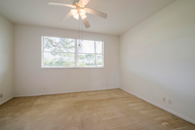 empty room with light carpet and ceiling fan