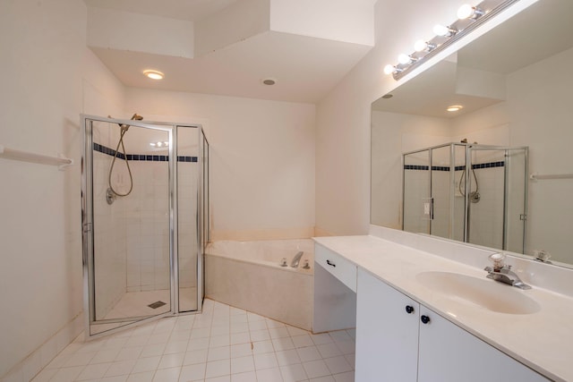 bathroom featuring shower with separate bathtub, tile patterned floors, and vanity