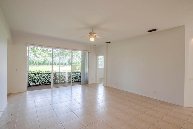 tiled empty room with ceiling fan