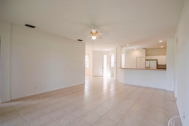 tiled empty room with ceiling fan