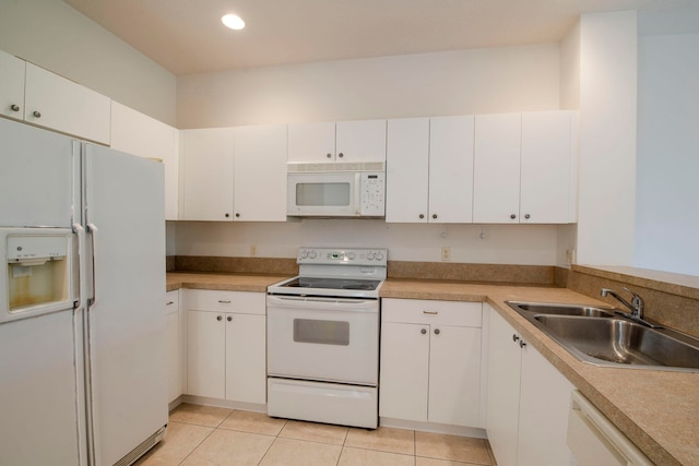 kitchen featuring white cabinets, sink, white appliances, and light tile patterned flooring