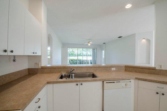 kitchen featuring dishwasher, kitchen peninsula, sink, and white cabinets