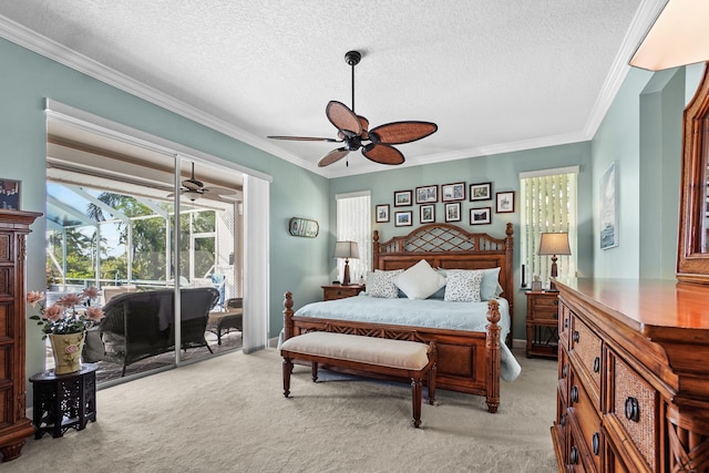 carpeted bedroom featuring a textured ceiling, ornamental molding, and ceiling fan