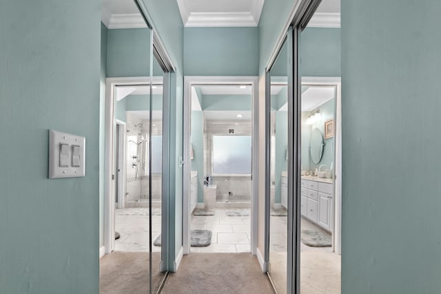 hallway featuring light colored carpet and crown molding