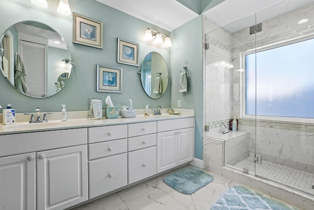 bathroom featuring marble finish floor, a sink, a marble finish shower, and double vanity