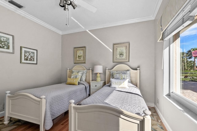 bedroom featuring ornamental molding, dark hardwood / wood-style flooring, and ceiling fan