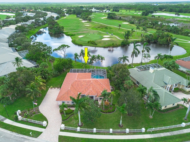 birds eye view of property with golf course view and a water view