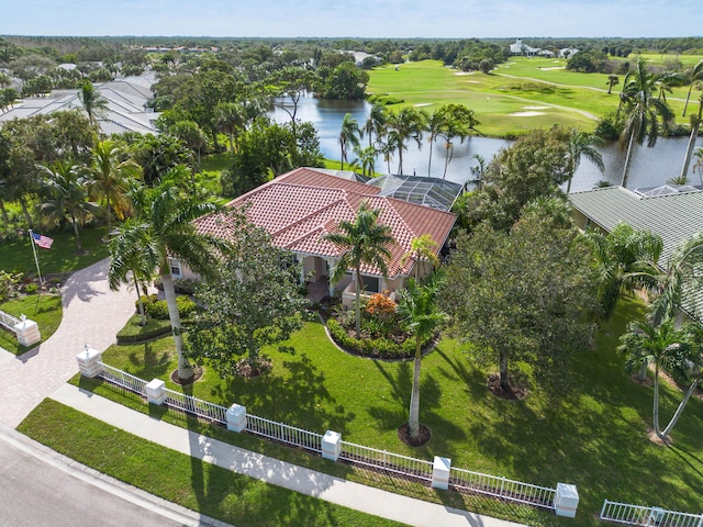 drone / aerial view featuring view of golf course and a water view