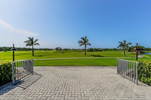 view of community featuring a lawn and golf course view