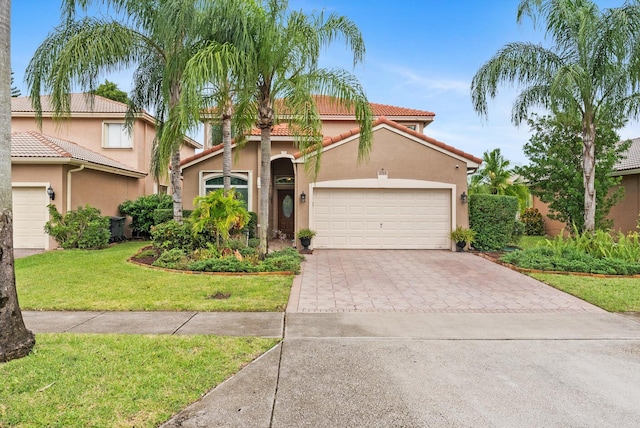 mediterranean / spanish-style house with a front lawn and a garage