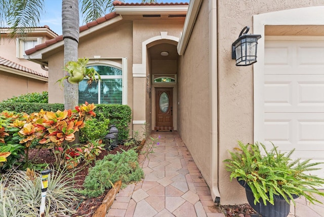 view of exterior entry featuring a garage