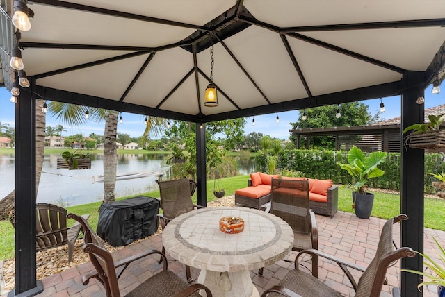 view of patio featuring a gazebo, an outdoor living space, and a water view