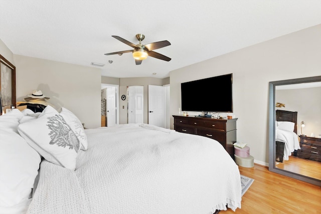 bedroom with light hardwood / wood-style floors and ceiling fan