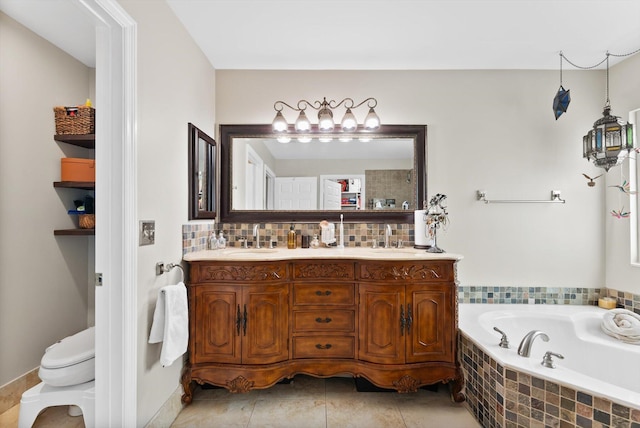 bathroom with tile patterned floors, vanity, a relaxing tiled tub, and toilet