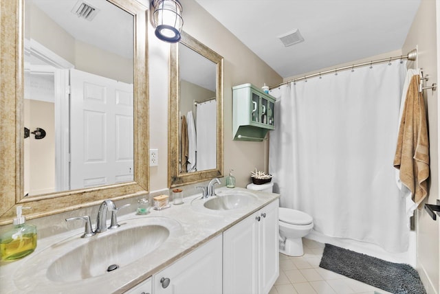 bathroom featuring tile patterned flooring, vanity, and toilet