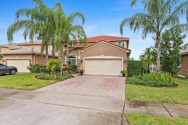 mediterranean / spanish house with a front yard and a garage