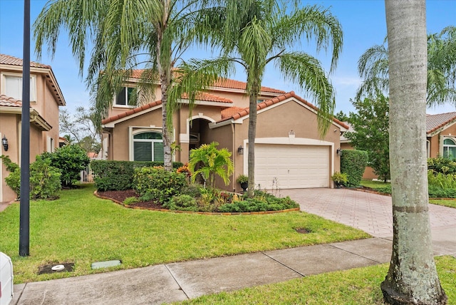 mediterranean / spanish-style home with a front yard and a garage