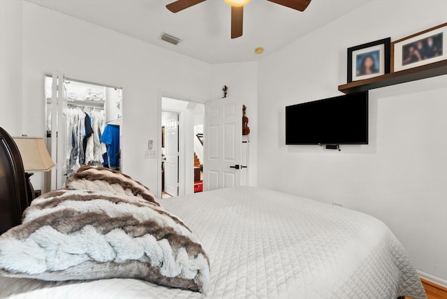 bedroom featuring hardwood / wood-style floors, ceiling fan, and a closet