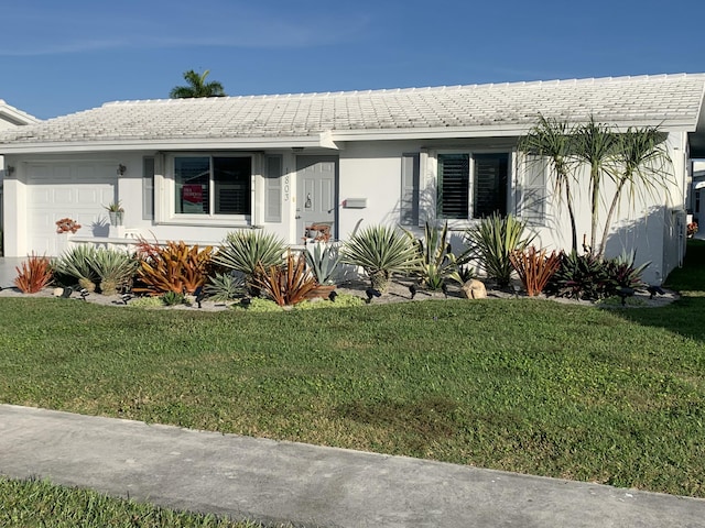 ranch-style house with a garage and a front lawn