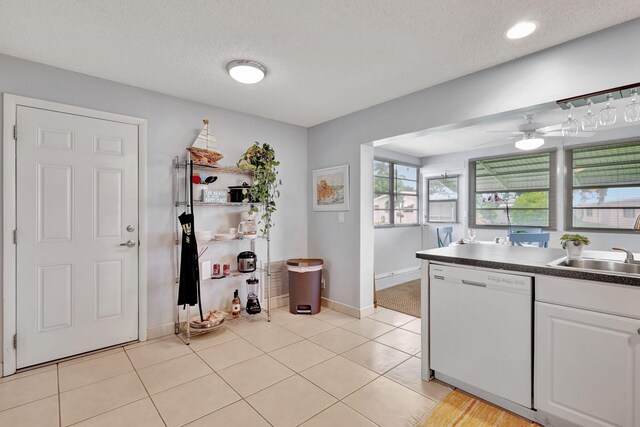 kitchen with white cabinetry, sink, ceiling fan, white dishwasher, and a textured ceiling